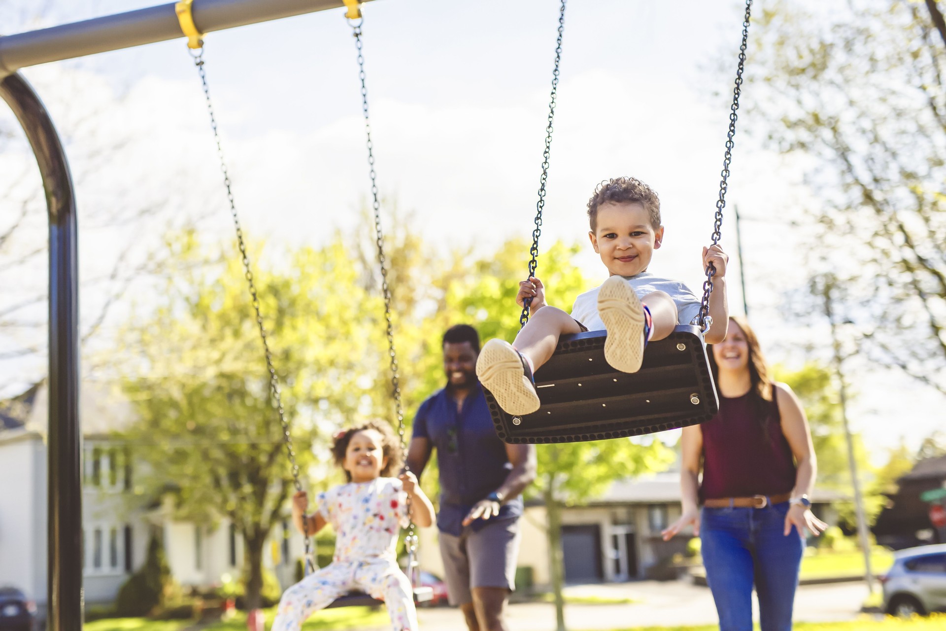Playtime Moments. family With child Swinging Having Fun on the Playground Outside, Sharing Laughter and Joyful Bonding In Park Outdoors