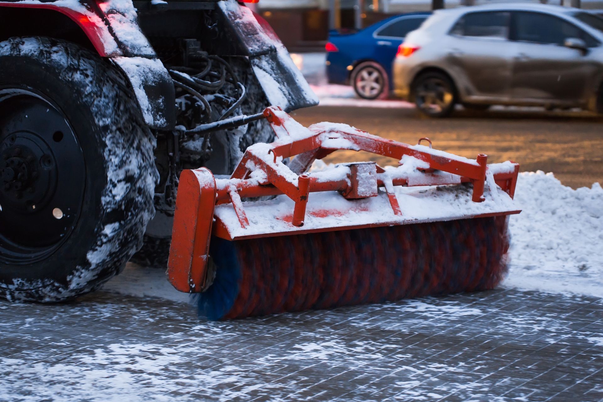 Tractor cleans snow brush